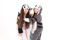 Cute teenage girls in kigurumi and sleep masks smiling and hug. World smile day