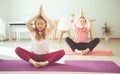 Cute teenager children making yoga at home during coronavirus quarantine