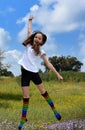 I try to fly . A girl with rainbow socks jumps up into the air Royalty Free Stock Photo