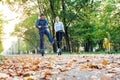 Cute teenager girl and boy riding electric kick scooter in the park. Royalty Free Stock Photo