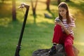 Cute teenager girl relaxing after riding by electric kick scooter Royalty Free Stock Photo