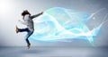 Cute teenager jumping with abstract blue scarf around her Royalty Free Stock Photo