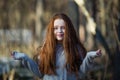 Cute teengirl with fiery red hair in the pine park. Royalty Free Stock Photo