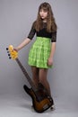 Cute tenage girl in dress with guitar Royalty Free Stock Photo