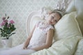 Cute tender girl teenager lies on the bed. Royalty Free Stock Photo