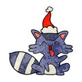 cute textured cartoon of a raccoon wearing santa hat