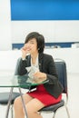 Cute Thai (Asian) businesswoman sitting and smiling in the office