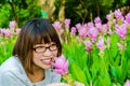 Cute Thai girl scent a pink Siam Tulip