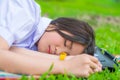 Cute Thai schoolgirl fall asleep during doing outdoor homework