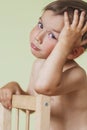 Cute Thinking Caucasan Little Boy Sitting On Chair Royalty Free Stock Photo