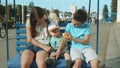 Cute three siblings riding on swing outdoor. Adorable kids spending time in park Royalty Free Stock Photo