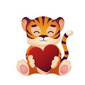 Cute tiger cub hugs a red heart Royalty Free Stock Photo