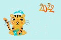 A cute tiger - a symbol of 2022 in a New Year's hat holds a gift. Children's new year card in cartoon style. Vector