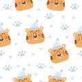 Cute tiger and snowflake winter seamless pattern. Hand drawn cute print for posters, t-shirts. Vector illustration.