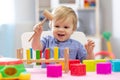 Cute toddler baby playing with wooden hammer block toy