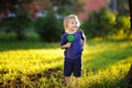 Cute toddler boy with big green lollipop at sunny park Royalty Free Stock Photo