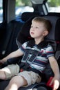 Cute toddler boy buckled up in a convertible car seat