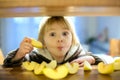 Cute toddler boy, eating green apple piece Royalty Free Stock Photo