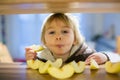 Cute toddler boy, eating green apple piece Royalty Free Stock Photo