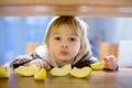 Cute toddler boy, eating green apple piece Royalty Free Stock Photo