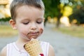 Cute toddler boy eating ice-cream. Kid with dirty face eating ice cream Royalty Free Stock Photo