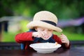 Cute toddler boy eating rice cereal outdoors Royalty Free Stock Photo