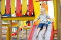 Cute toddler boy having fun on slide on playground. Active outdoors games for little children Royalty Free Stock Photo