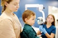 A cute toddler boy with his mother are at an appointment with a pediatric ENT to prepare for preschool Royalty Free Stock Photo