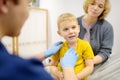 A cute toddler boy with his mother are at an appointment with a pediatrician. The doctor ENT is examines lymph nodes of a little Royalty Free Stock Photo