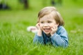 Cute toddler boy playing in blooming cherry tree garden on beautiful spring day. Adorable baby having fun outdoors Royalty Free Stock Photo