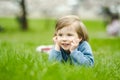 Cute toddler boy playing in blooming cherry tree garden on beautiful spring day. Adorable baby having fun outdoors Royalty Free Stock Photo