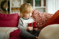 Cute toddler boy playing with red toy car. Small child having fun with toys. Kid spending time in a cozy living room at home Royalty Free Stock Photo