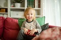 Cute toddler boy playing with red toy car. Small child having fun with toys. Kid spending time in a cozy living room at home Royalty Free Stock Photo