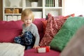 Cute toddler boy playing with red toy car. Small child having fun with toys. Kid spending time in a cozy living room at home Royalty Free Stock Photo