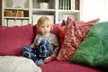 Cute toddler boy playing with red toy car. Small child having fun with toys. Kid spending time in a cozy living room at home Royalty Free Stock Photo