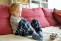 Cute toddler boy playing with red toy car. Small child having fun with toys. Kid spending time in a cozy living room at home Royalty Free Stock Photo