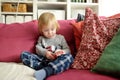 Cute toddler boy playing with red toy car. Small child having fun with toys. Kid spending time in a cozy living room at home Royalty Free Stock Photo