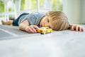 Cute toddler boy playing with yellow toy car. Small child having fun with toys. Kid spending time in a cozy living room at home Royalty Free Stock Photo