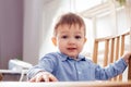 the cute toddler boy is sitting at the table Royalty Free Stock Photo