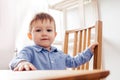 the cute toddler boy is sitting at the table Royalty Free Stock Photo