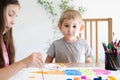 Cute toddler boy spending time with his sister Royalty Free Stock Photo