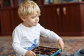 Cute toddler boy of two years eating chocolate