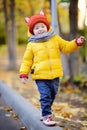 Cute toddler boy wearing hat with ears playing outdoors at autumn day Royalty Free Stock Photo