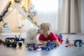 Cute toddler child, blond boy, playing with colofrul plastic blocks, construction toys Royalty Free Stock Photo