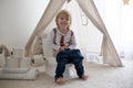 Cute toddler child, boy, sitting on a baby toilet potty, playing