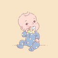 Little baby boy in blue pajamas sit, hold teething ring