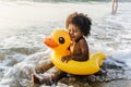 Cute toddler with duck tube on the beach