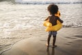 Cute toddler with duck tube on the beach