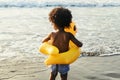 Cute toddler with duck tube on the beach