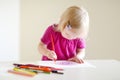 Cute toddler girl drawing with colorful pencils Royalty Free Stock Photo